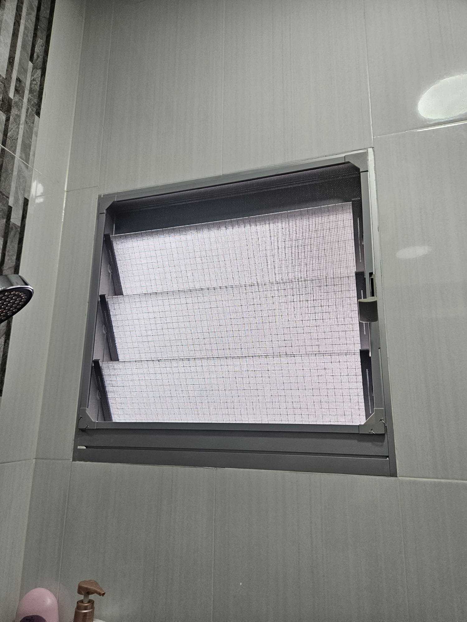 Magnetic window mesh on bathroom window for ventilation and insect protection